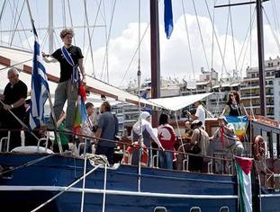 Crew and Pro-Palestinian activists stand on board one of the French boats of a flotilla bound for Gaza.