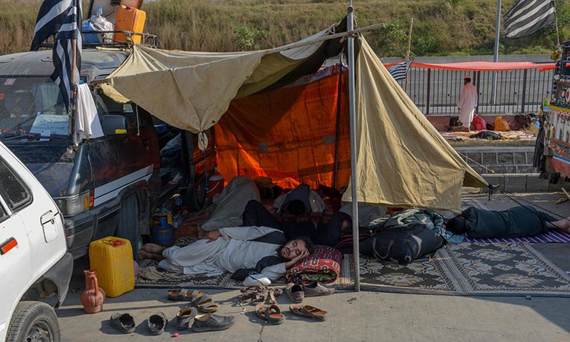 Participants rest during the ongoing 'Azadi March' in Islamabad on November 3, 2019.  AFP